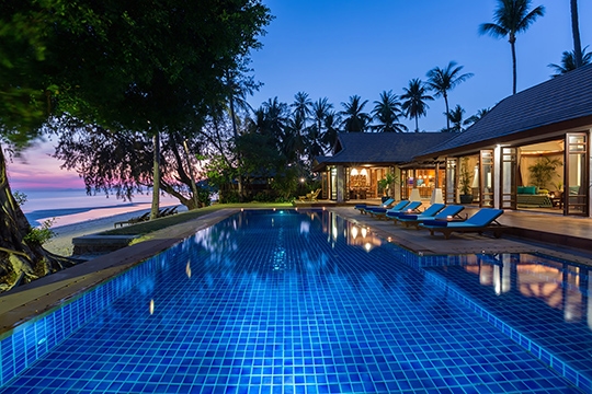 Pool and villa facade by night